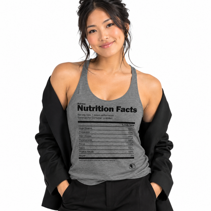 A woman wearing a heather gray racerback tank top with a black 'Nutrition Facts' graphic printed on the front, styled with an open black blazer against a plain white background.
