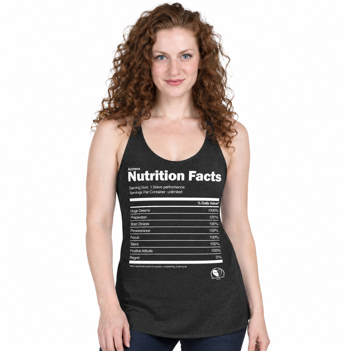 A woman with curly red hair wearing a dark heather gray racerback tank top with a white 'Nutrition Facts' graphic printed on the front, set against a plain white background.