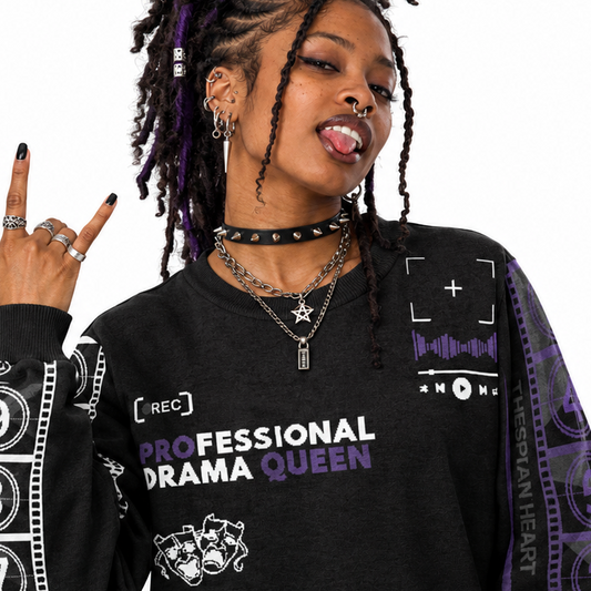 A woman modeling a black graphic sweatshirt with purple and white text reading 'PROFESSIONAL DRAMA QUEEN' and film reel graphics, posed against a plain white background.