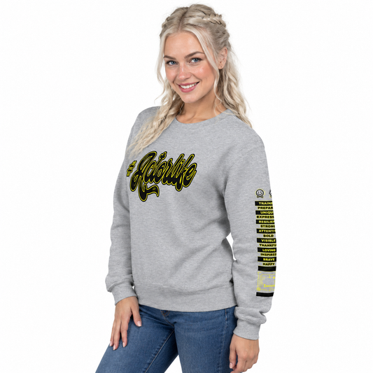 A woman modeling a heather gray crewneck sweatshirt with 'The Athletic' written across the chest in black and yellow, and a list of sports on the right sleeve.