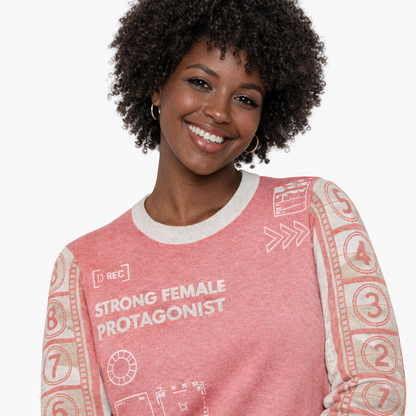 Woman wearing a pink sweater with text and patterns on a white background