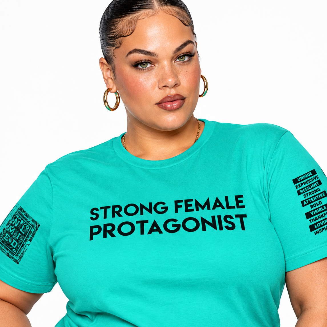 A woman wearing a bright turquoise short-sleeve graphic T-shirt with the words 'STRONG FEMALE PROTAGONIST' printed in black across the chest, plus black text graphics on both sleeves, against a plain white background.