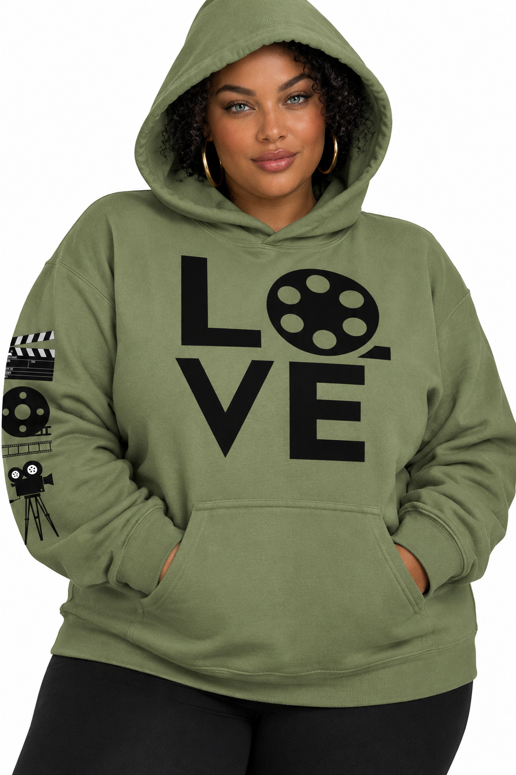 A woman wearing a heather olive green pullover hoodie with a black graphic print that spells 'LOVE' using a film reel and script letters, paired with black leggings against a white background.
