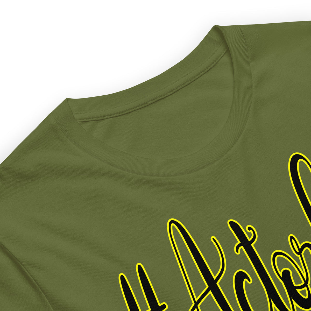 Close-up of an olive green crewneck t-shirt featuring a black script graphic outlined in yellow, set against a plain white background.